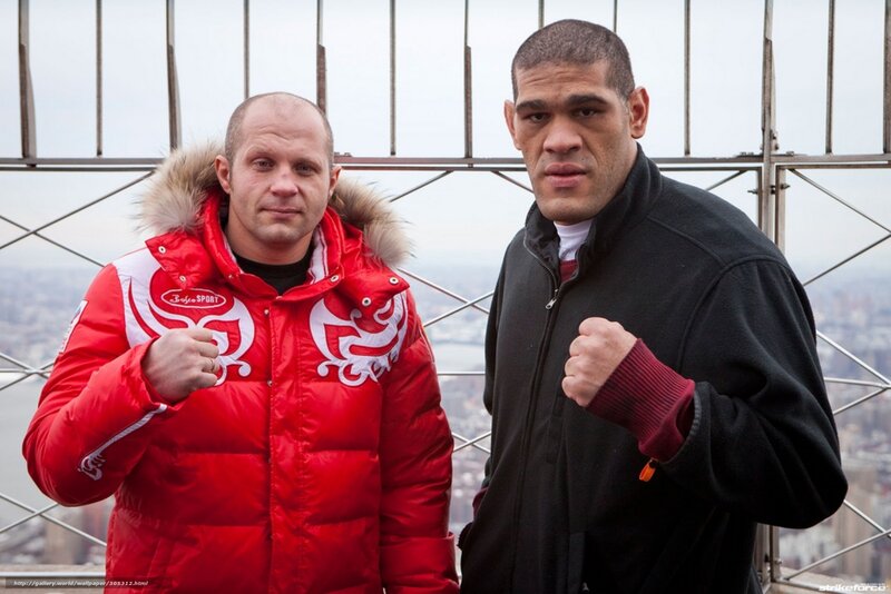Two fighters pose on a tower