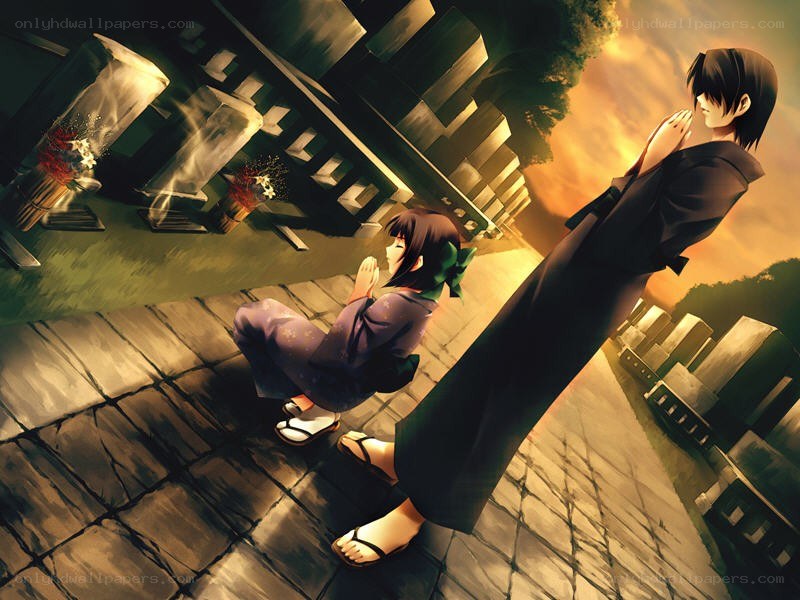 Two figures at a shrine at sunset