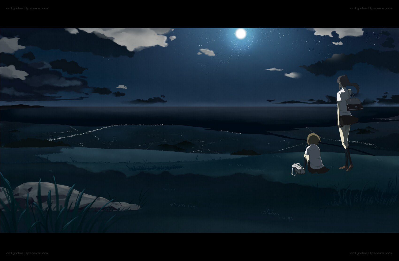 Two figures at night by the sea