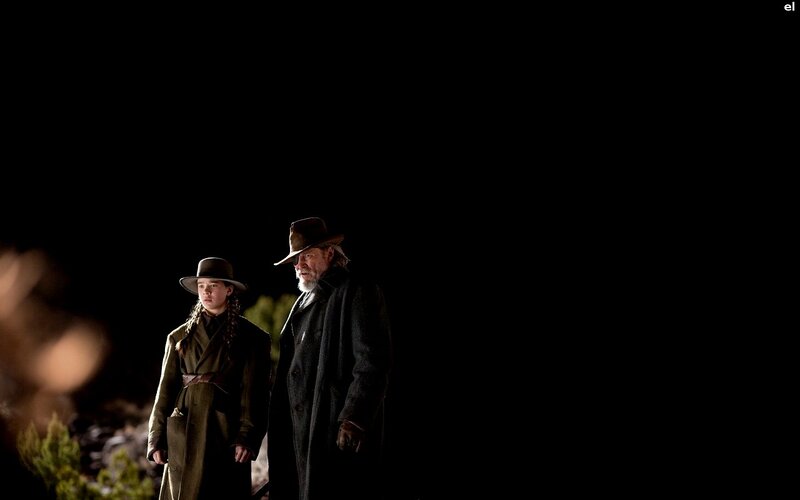 Two figures in coats at night