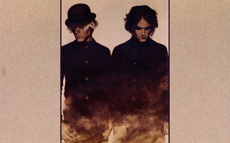 two figures in dark coats