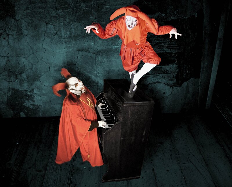 Two Figures in Red Costumes