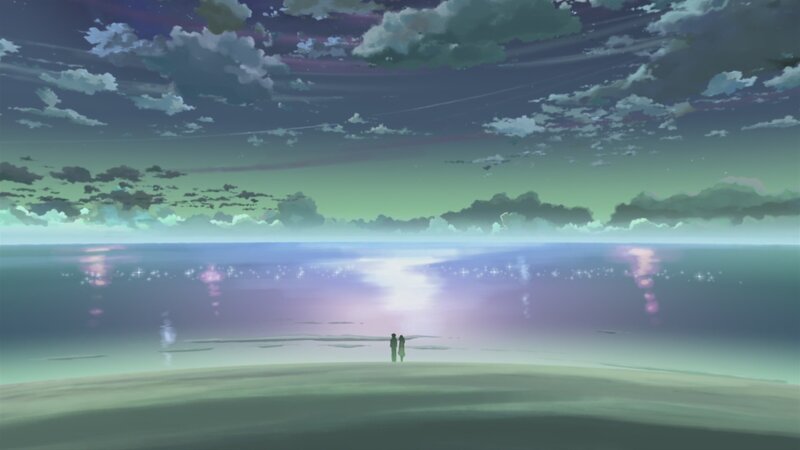 two figures on a beach at dusk