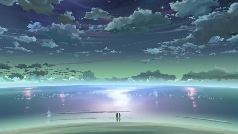 two figures on a beach at night
