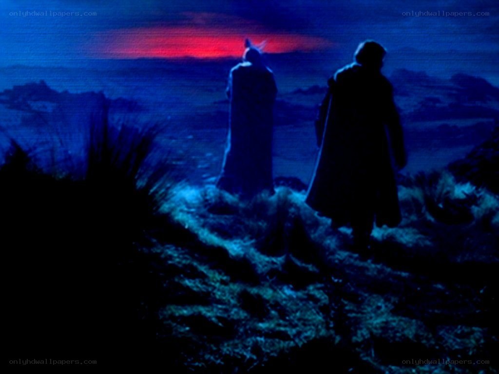 two figures on a hill at dusk