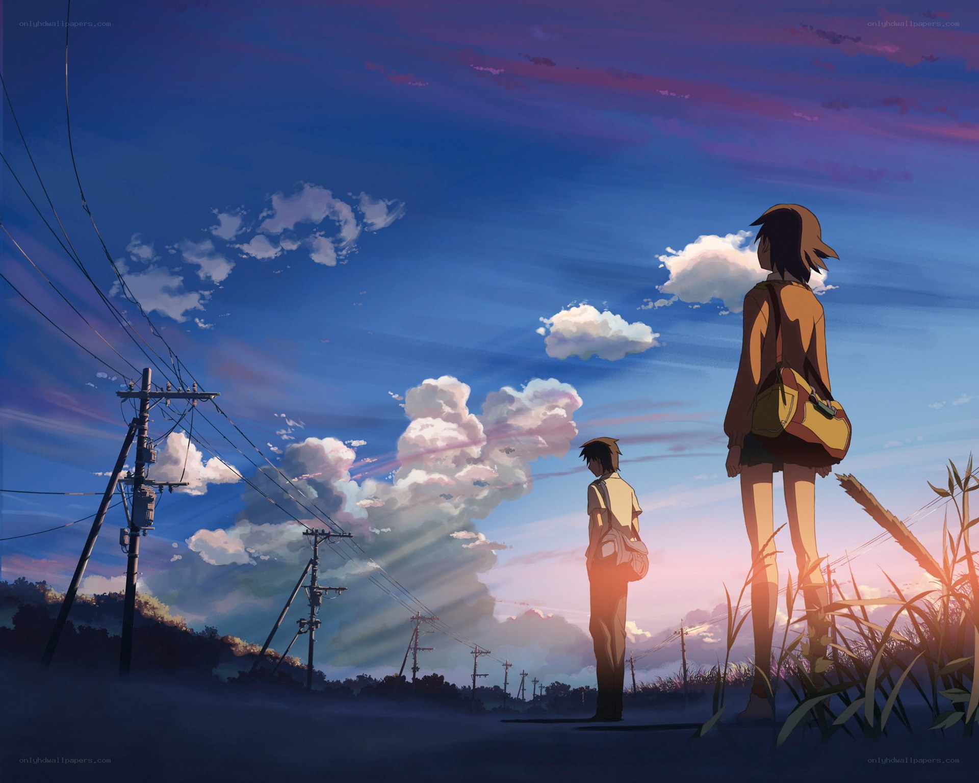 Two figures watch the sunset