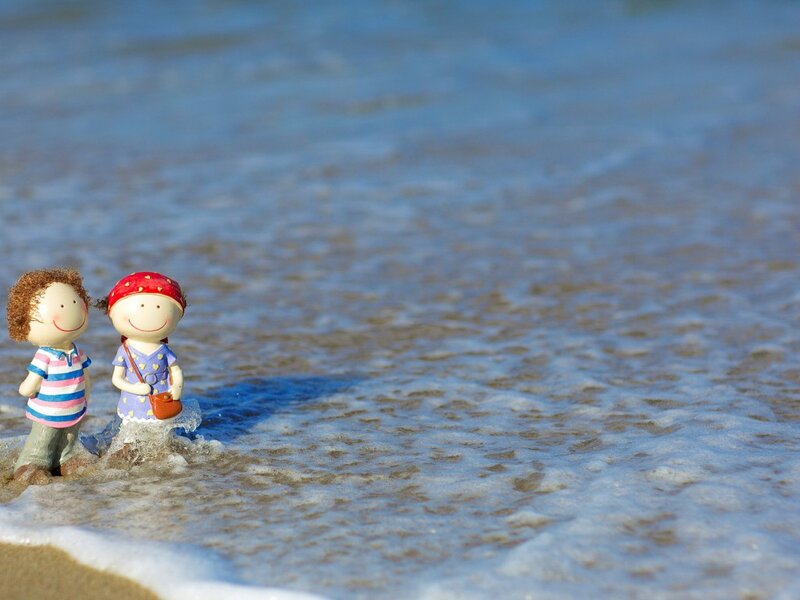 Two Figurines on Beach