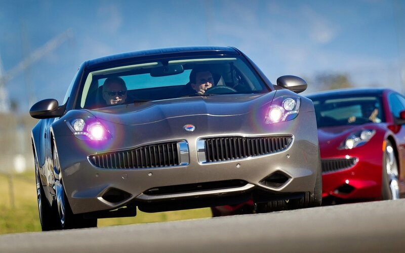 Two Fisker Karma cars on a road