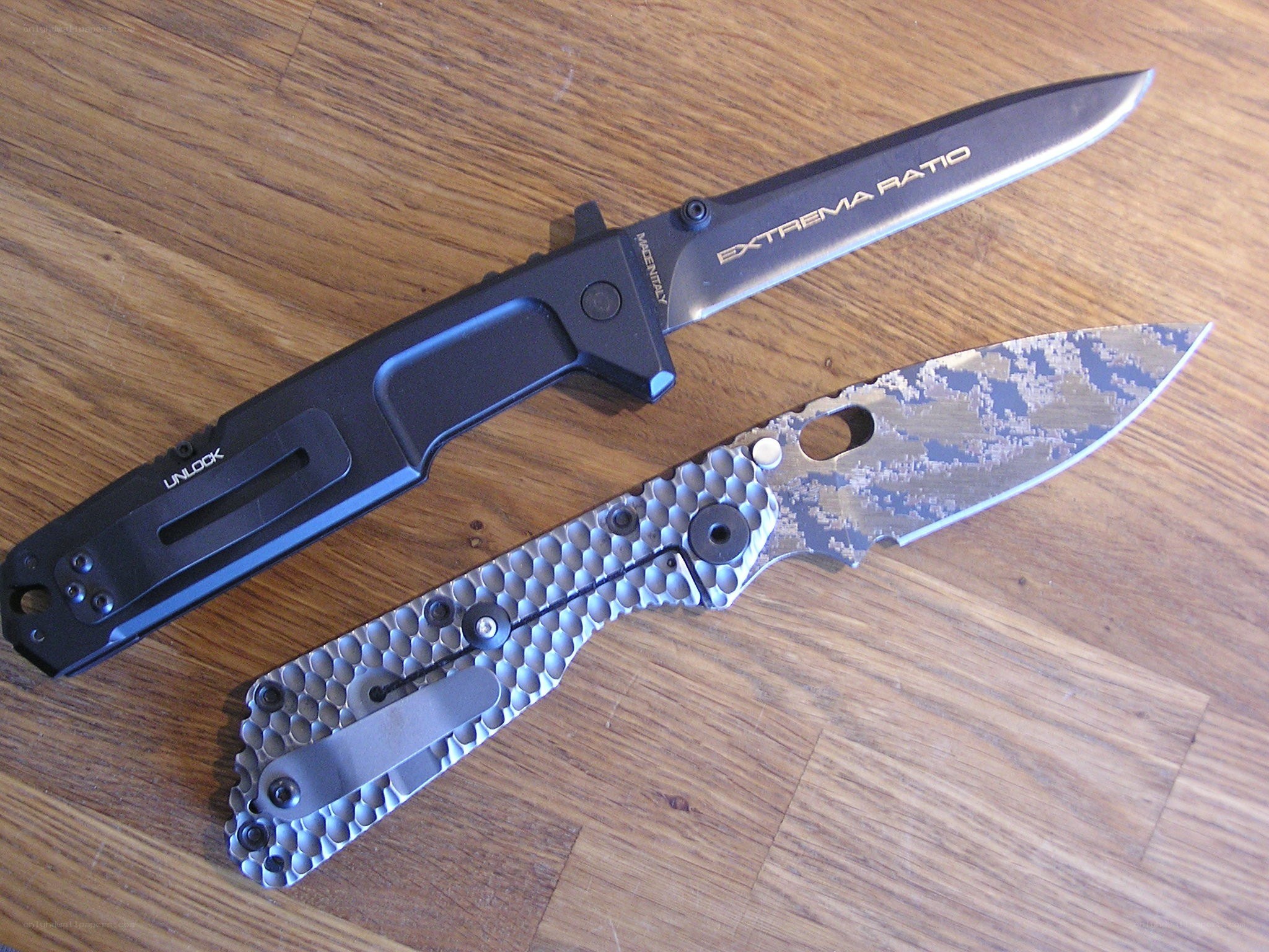 Two folding knives on wood