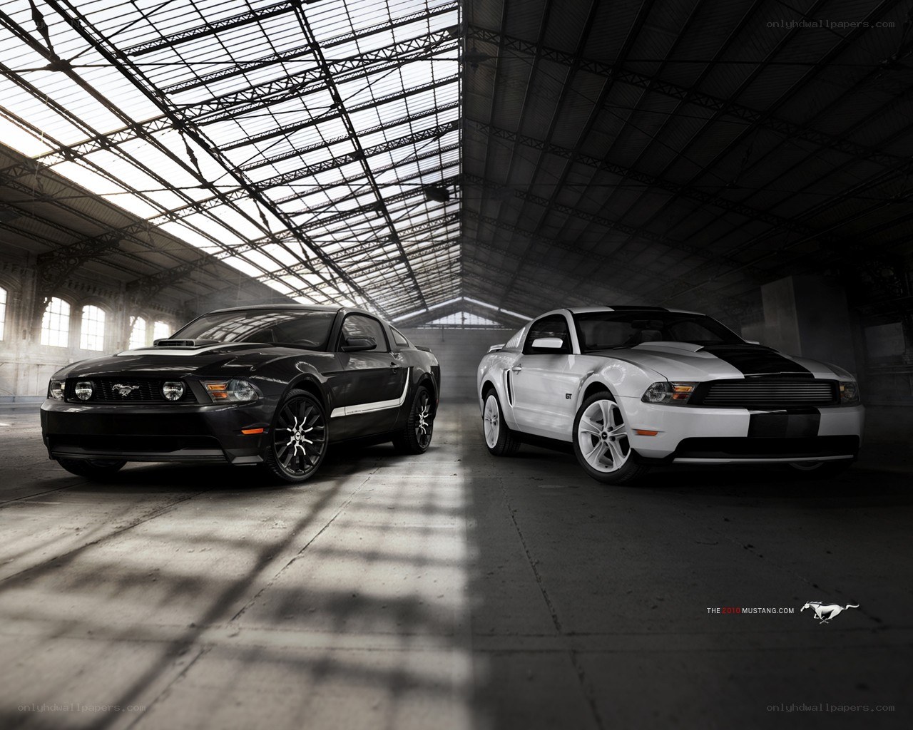 Two Ford Mustangs in a warehouse