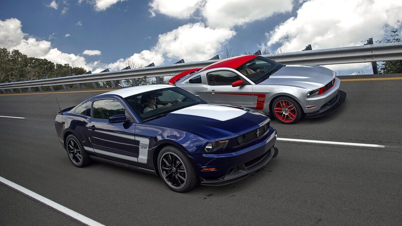 Two Ford Mustangs on a highway
