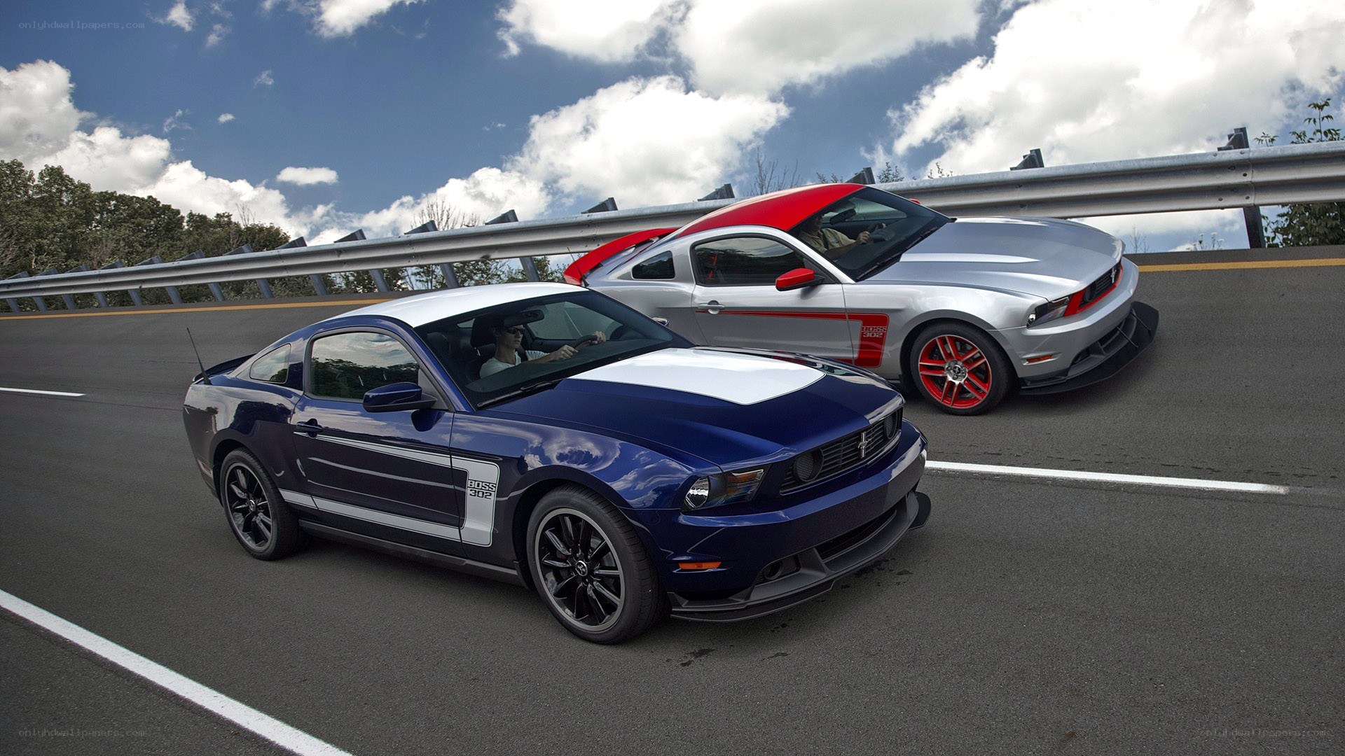 Two Ford Mustangs on a highway