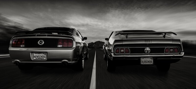 Two Ford Mustangs on a road