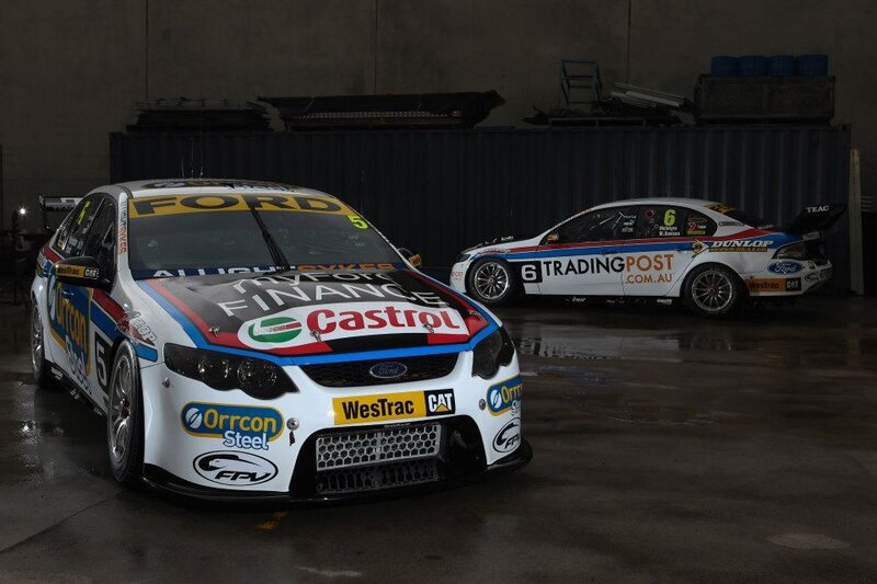 Two Ford racing cars in garage