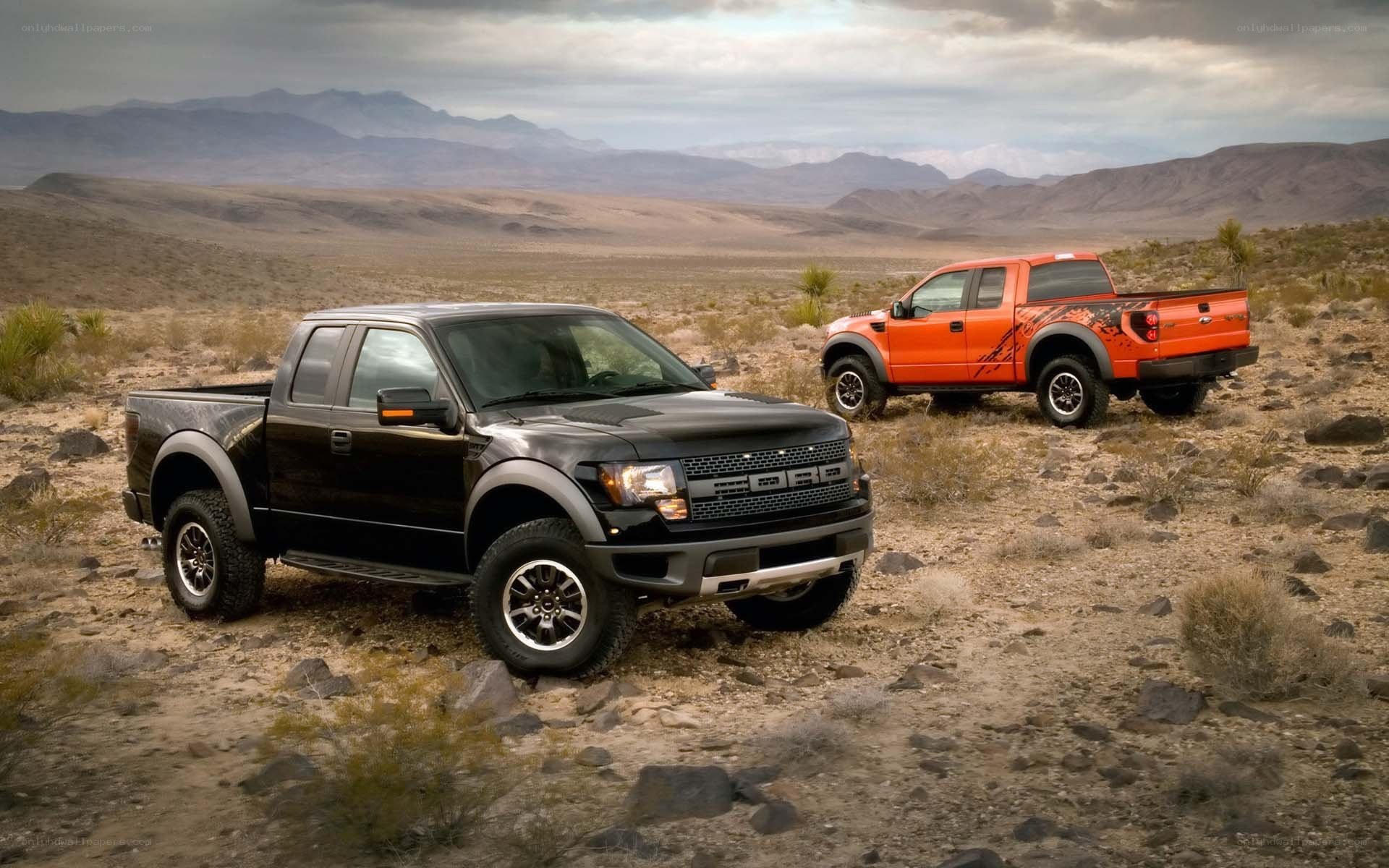 Two Ford Raptor trucks in desert