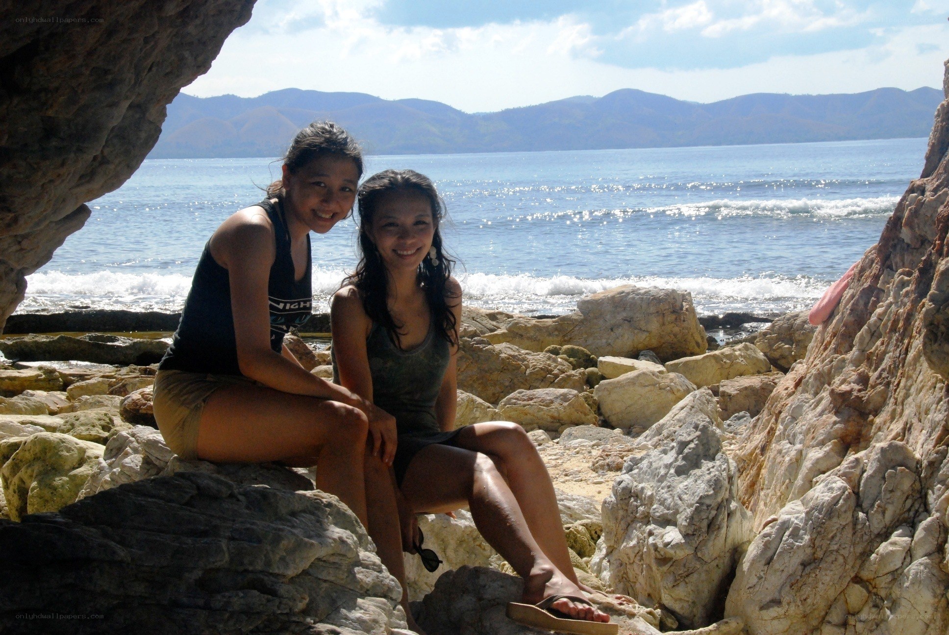 Two friends at a rocky beach