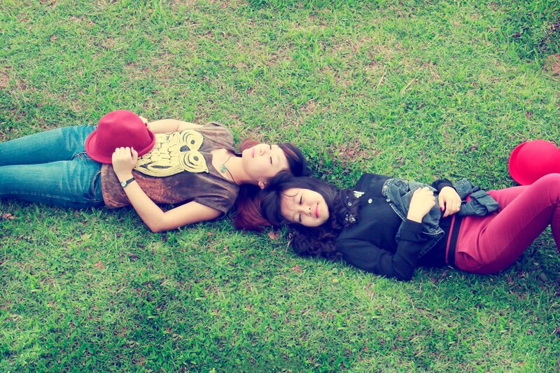 Two friends lying on grass