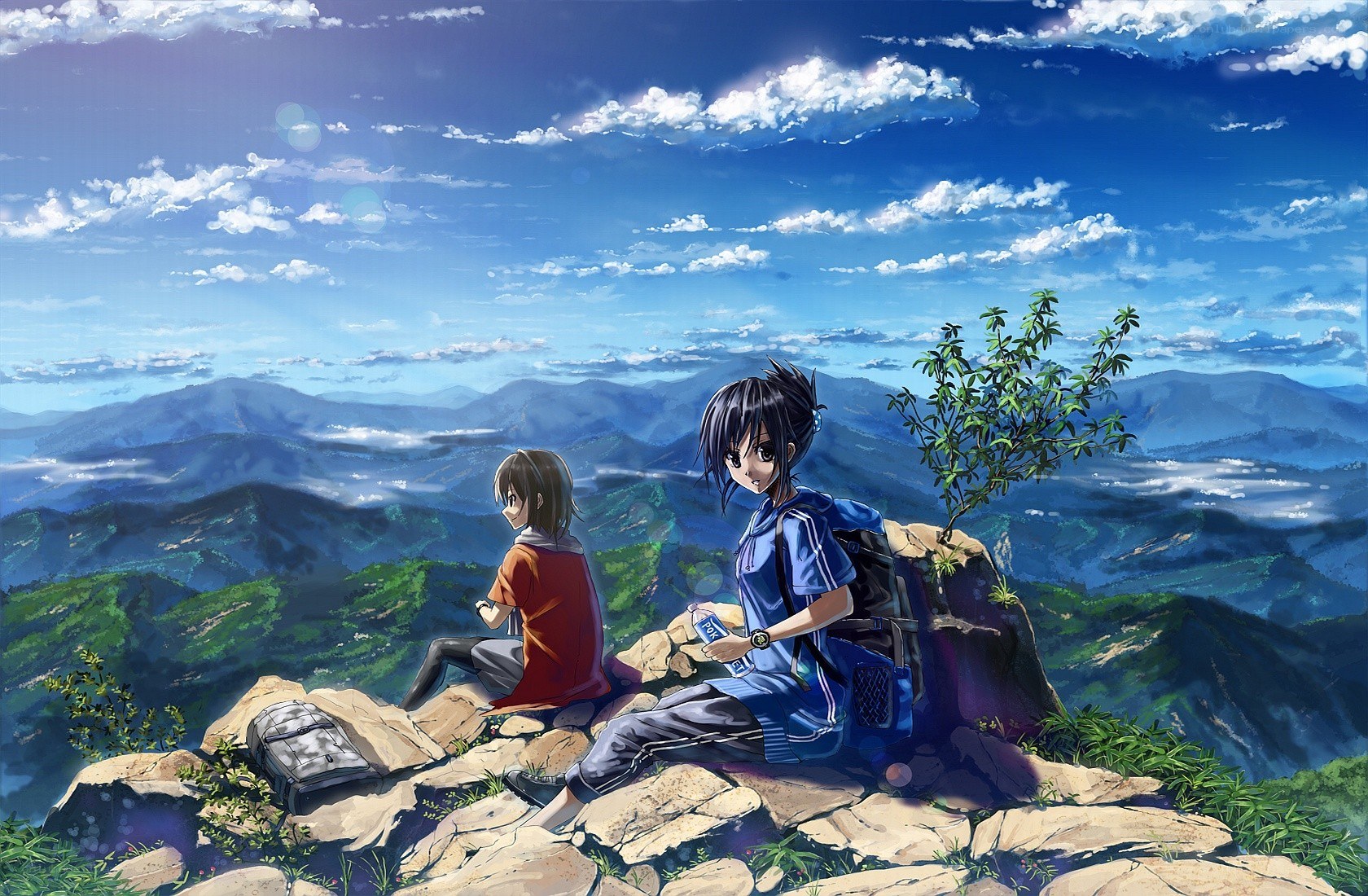 Two friends on a mountain peak