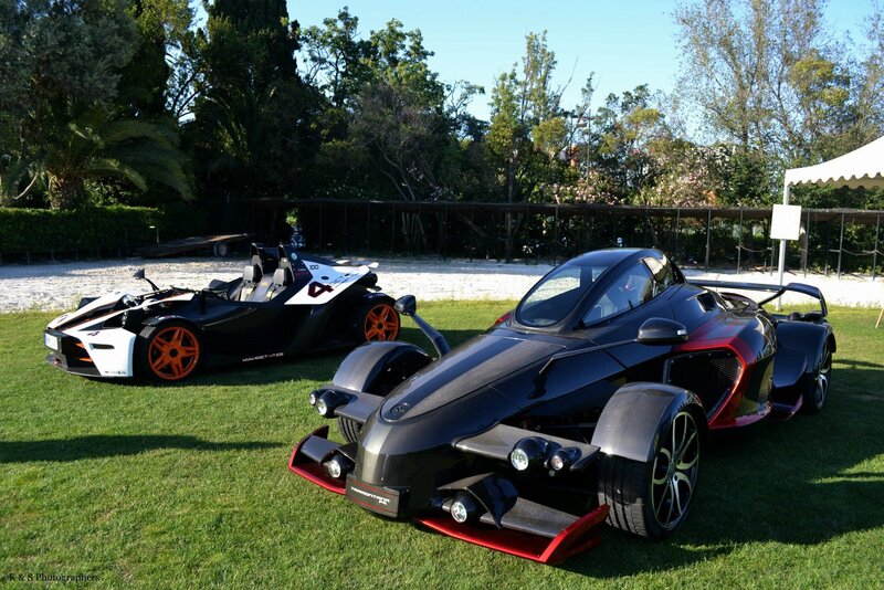 Two futuristic sports cars on grass