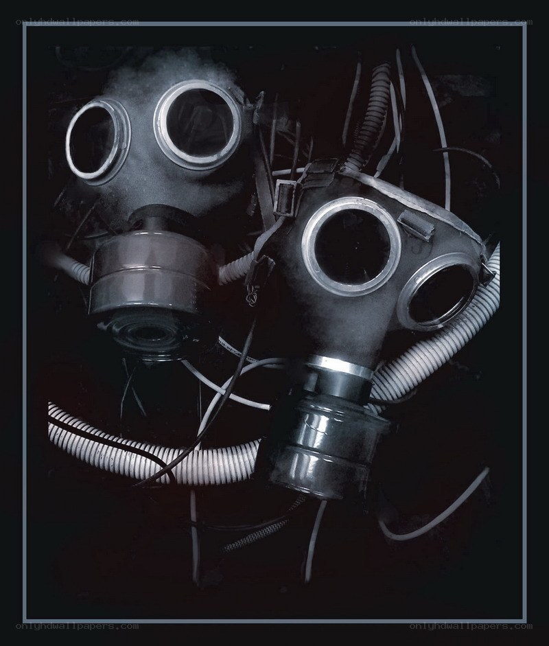two gas masks in dark setting