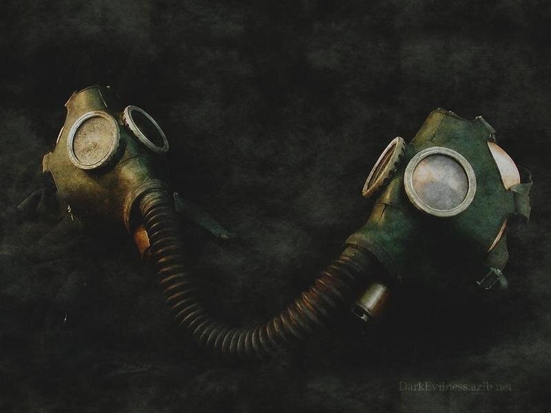 two gas masks on dark background