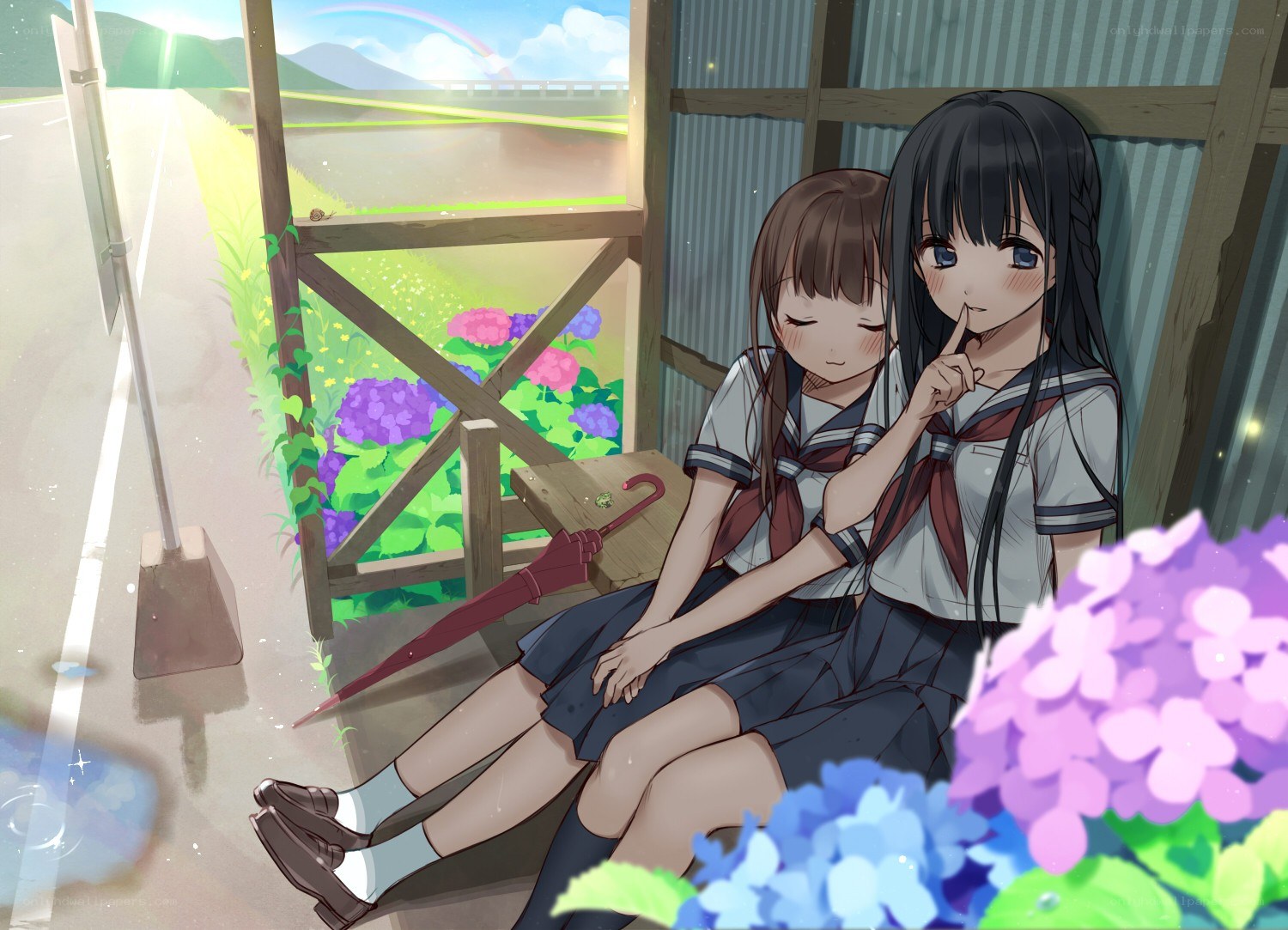 Two girls at a bus stop