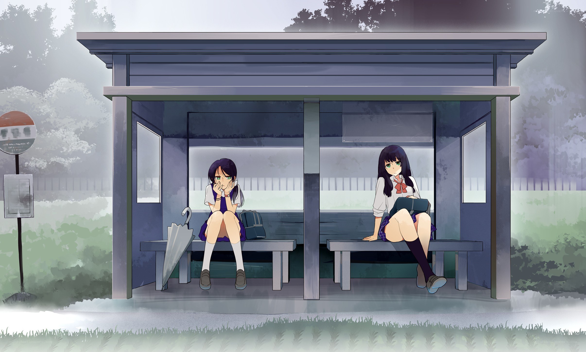 Two girls at a bus stop