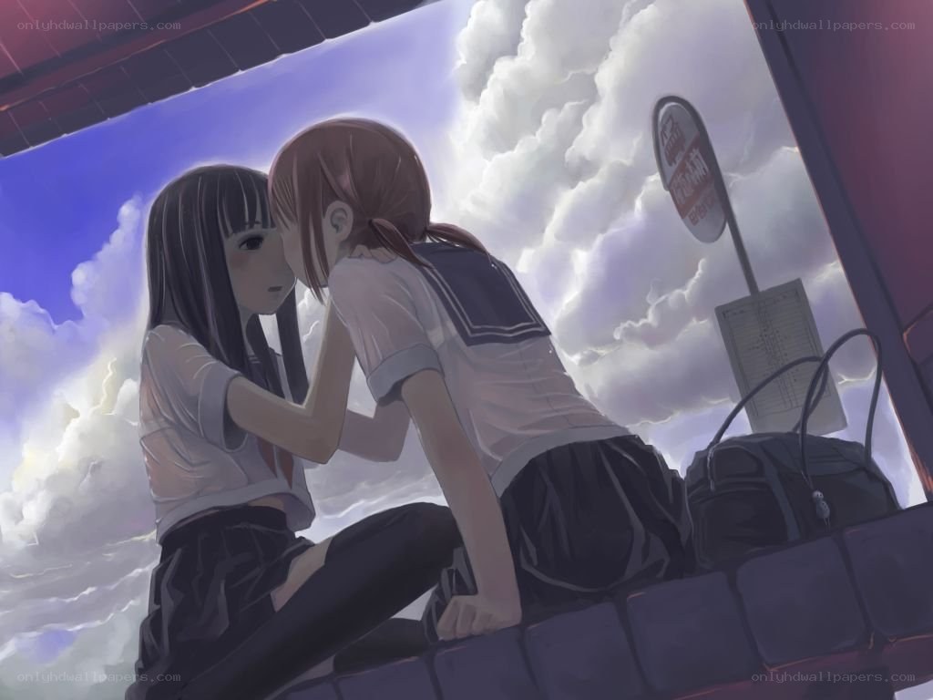 Two girls at a bus stop
