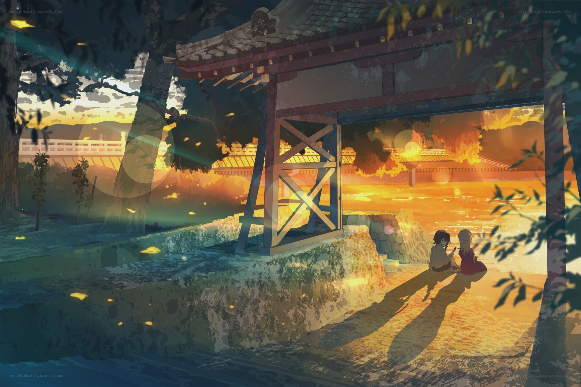 Two girls at a shrine at sunset