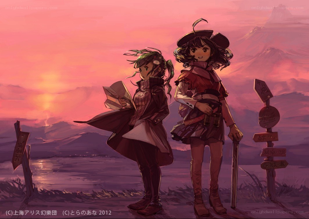 Two girls at sunset with map