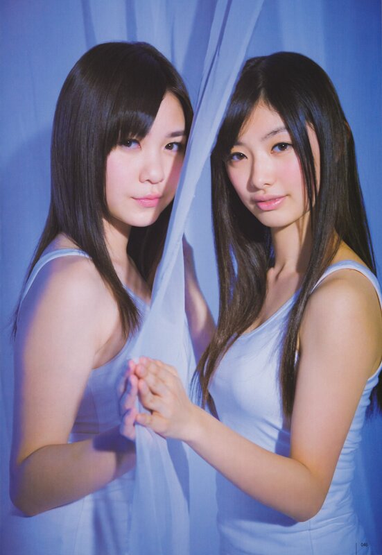 Two girls behind a sheer curtain