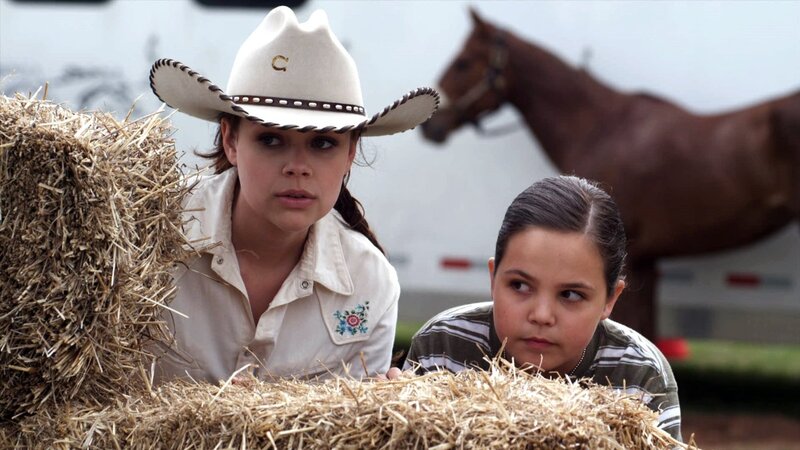 Two Girls Behind Hay Bales