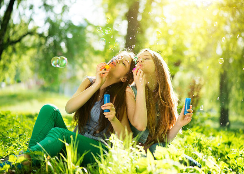 Two Girls Blowing Bubbles — Green, Playful
