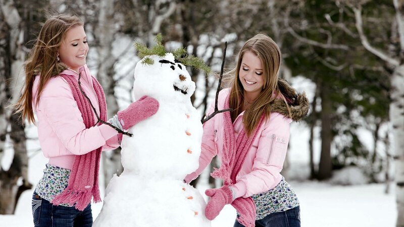 Two Girls Building Snowman