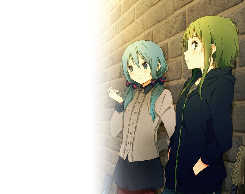 Two girls by a brick wall