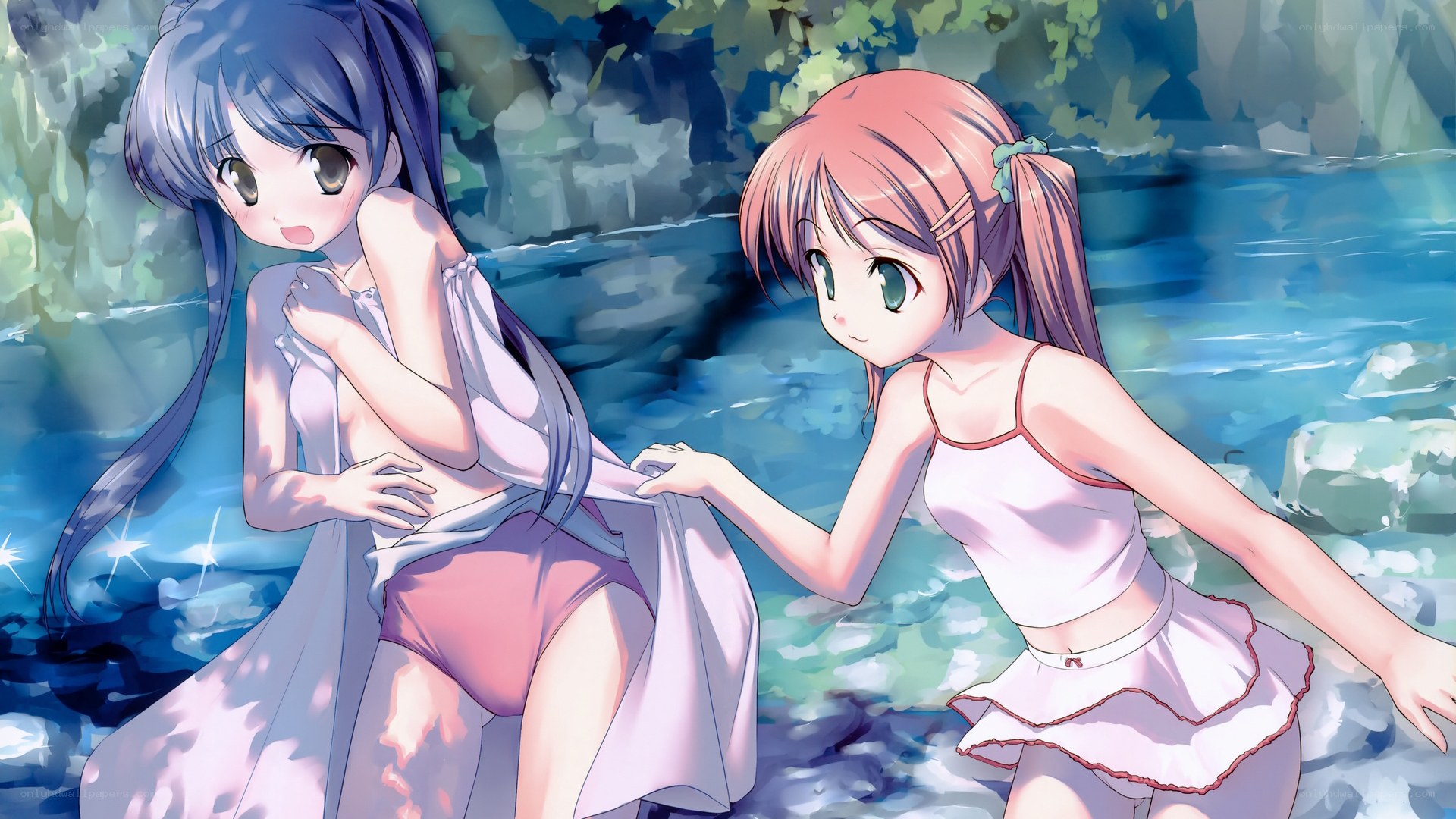 Two girls by a stream