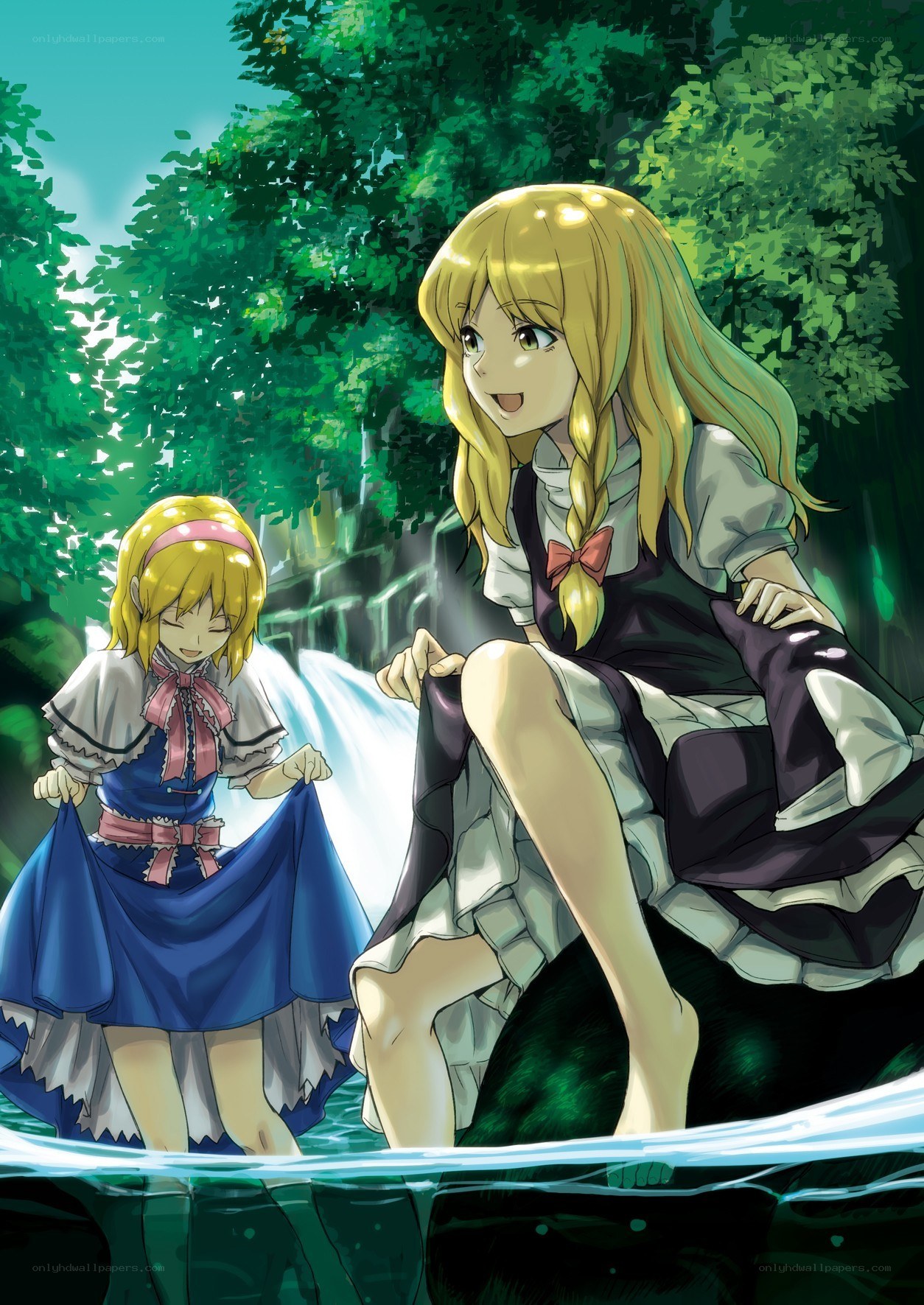 Two girls by a waterfall