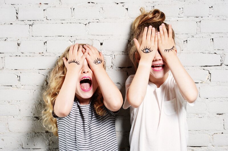 Two Girls Covering Eyes