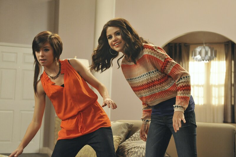 Two girls dancing in a living room
