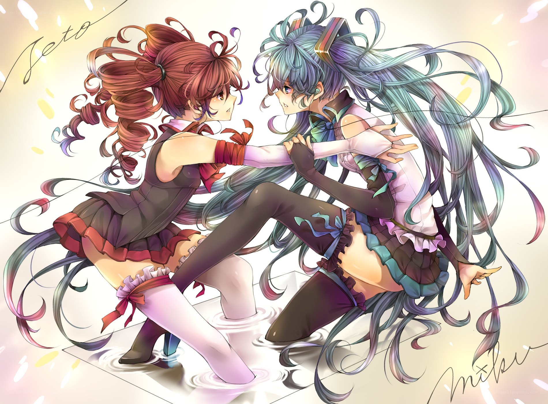 Two girls dancing in water