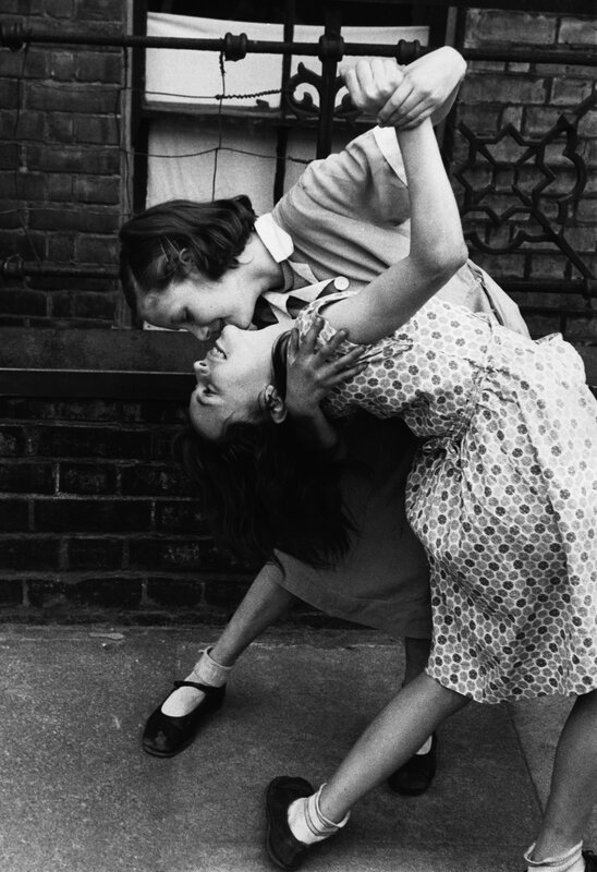 Two girls dancing on a street