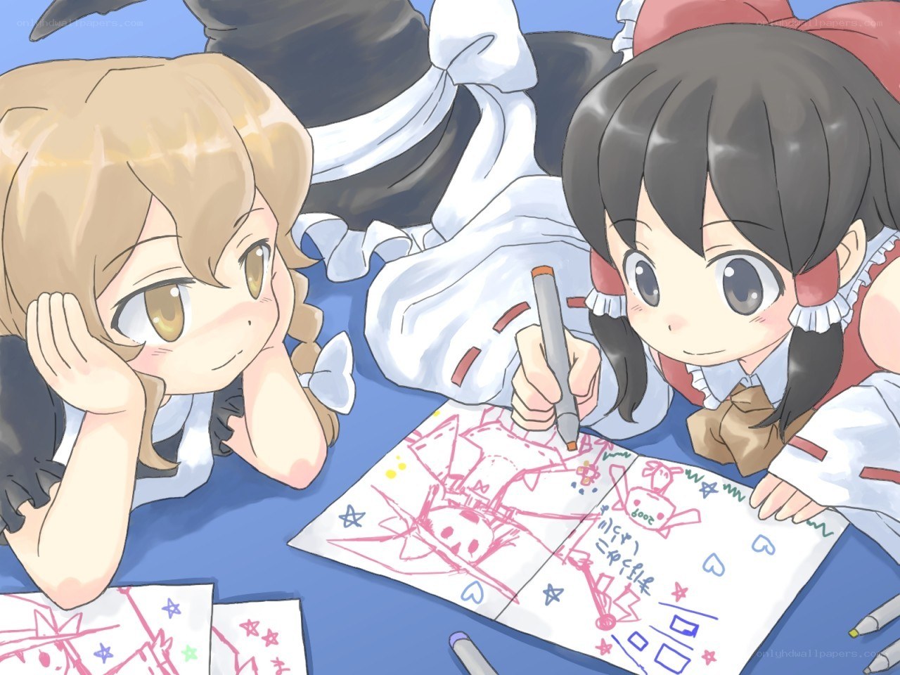 Two girls drawing together