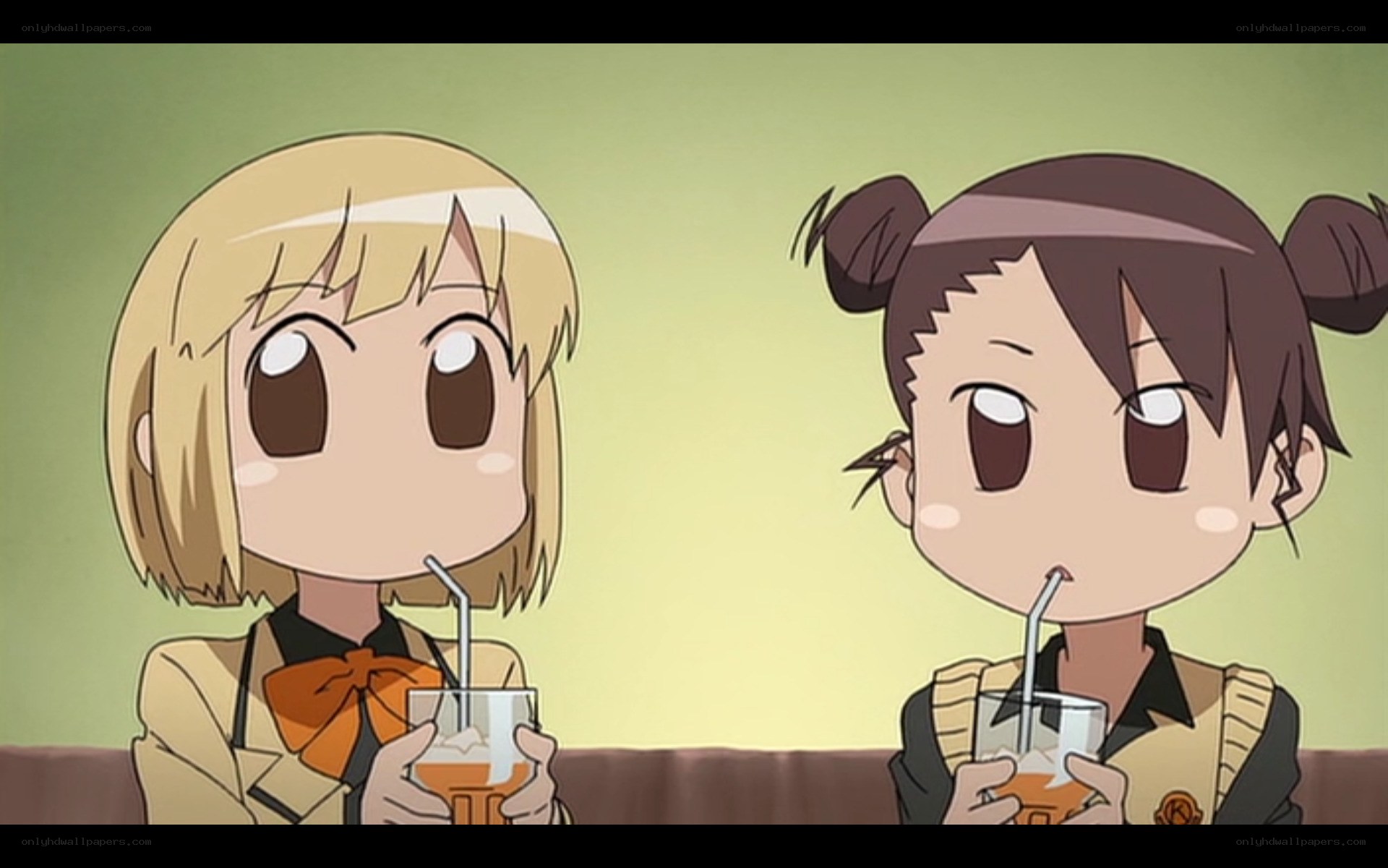 Two girls drinking juice