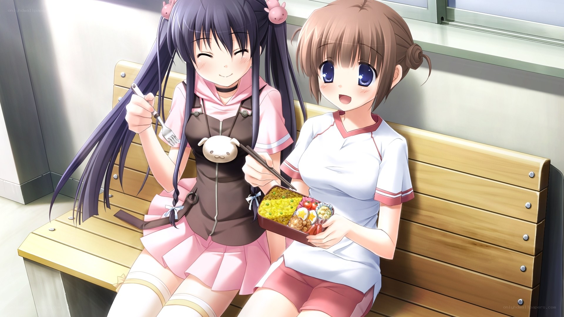 Two girls eating bento boxes