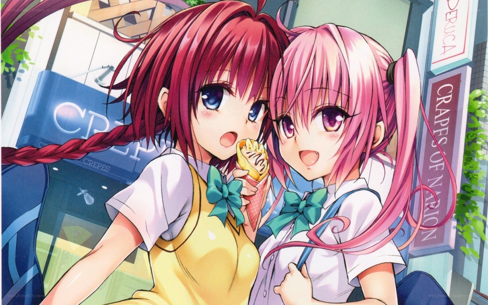 Two girls eating crepes