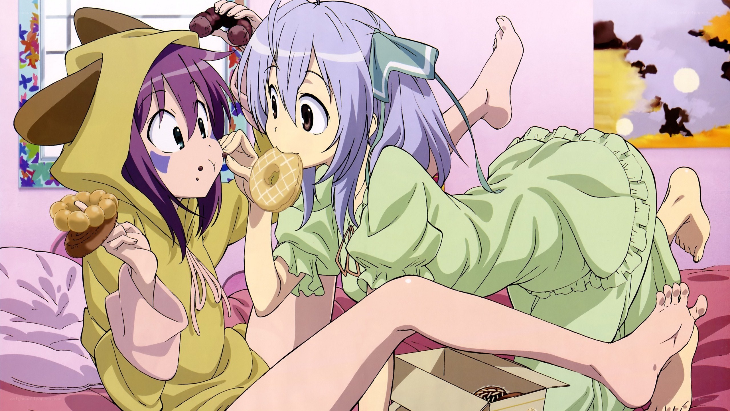 Two girls eating donuts