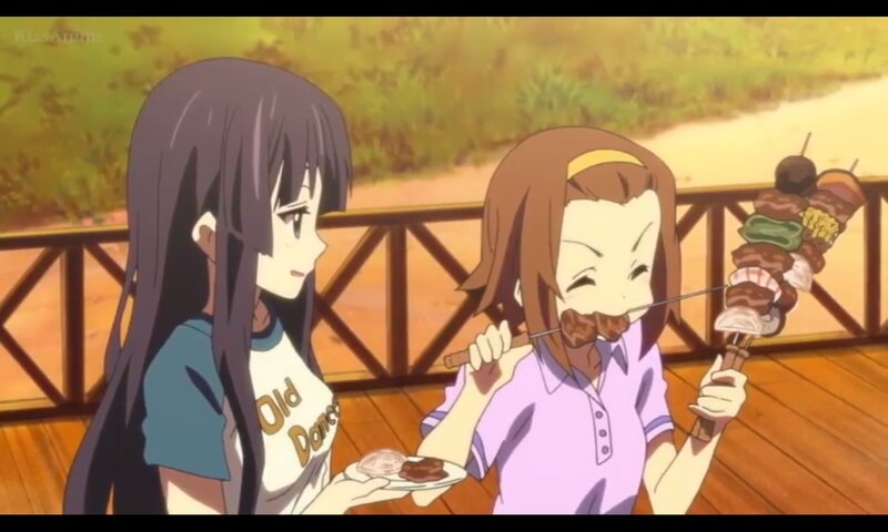 Two Girls Eating Skewers