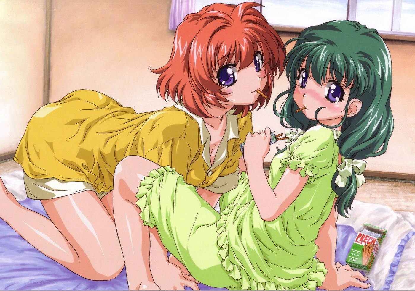Two girls eating snacks on bed