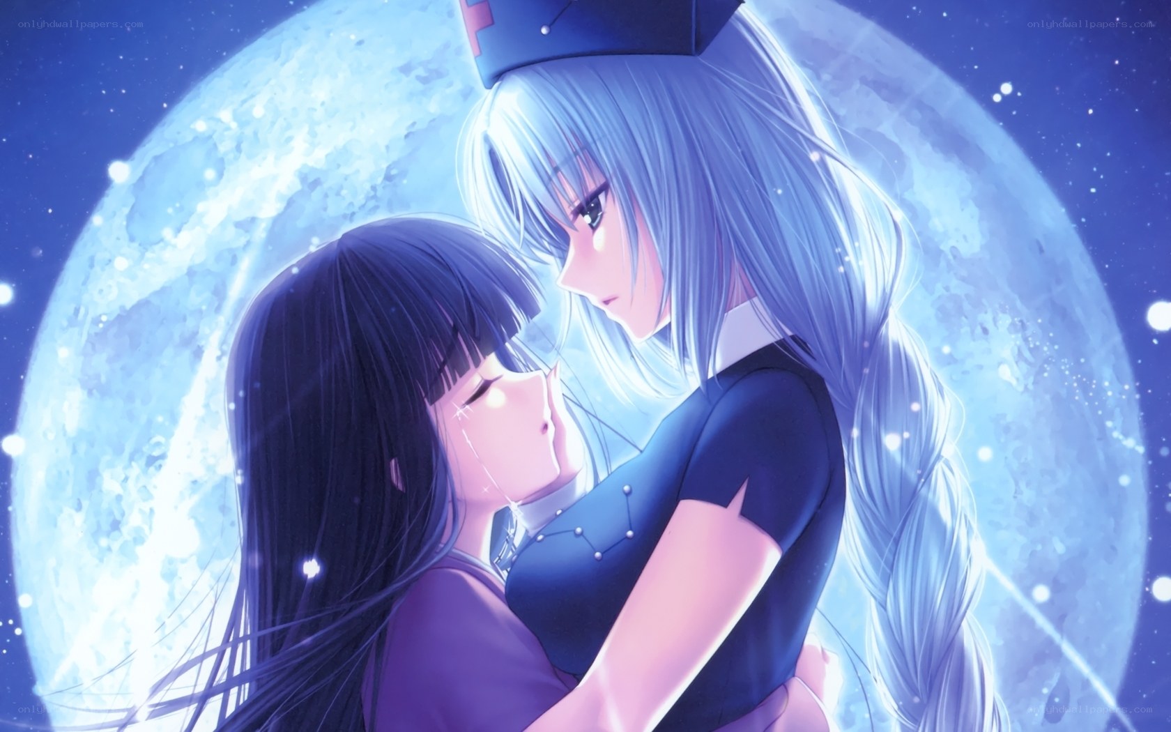 Two girls embrace under the moon