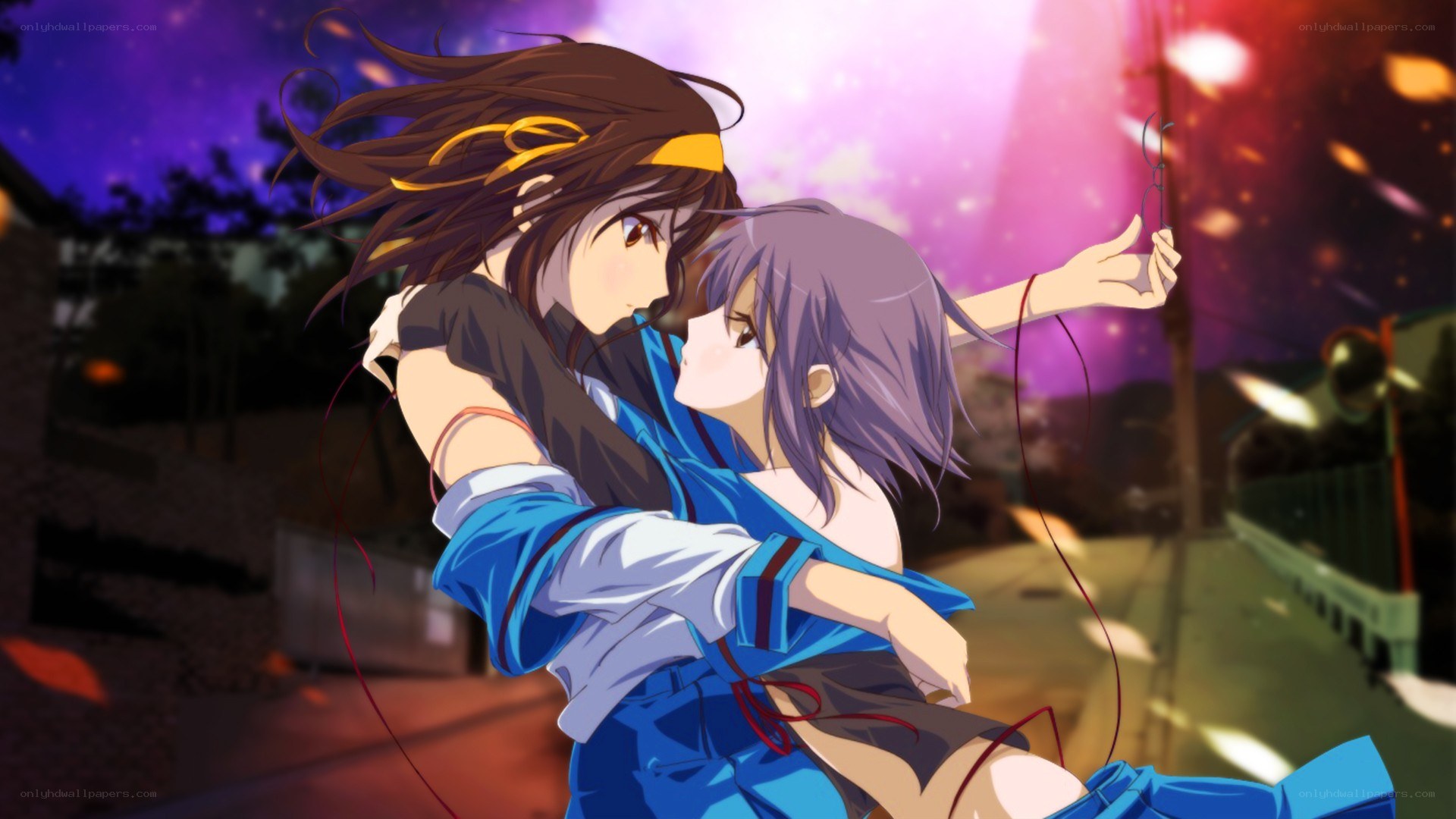 Two girls embracing at night
